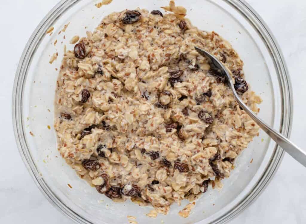 Soaked overnight oats in a bowl with a spoon.
