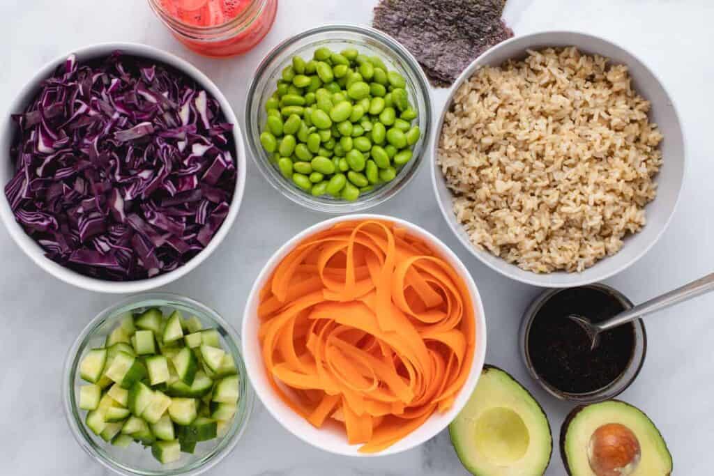 Ingredients for vegan sushi bowl in bowls.