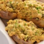 Vega stuffed potatoes with cheese and broccoli sauce in a baking dish.