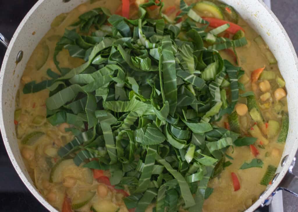 Cooked vegetable curry with the green parts of bok choy.