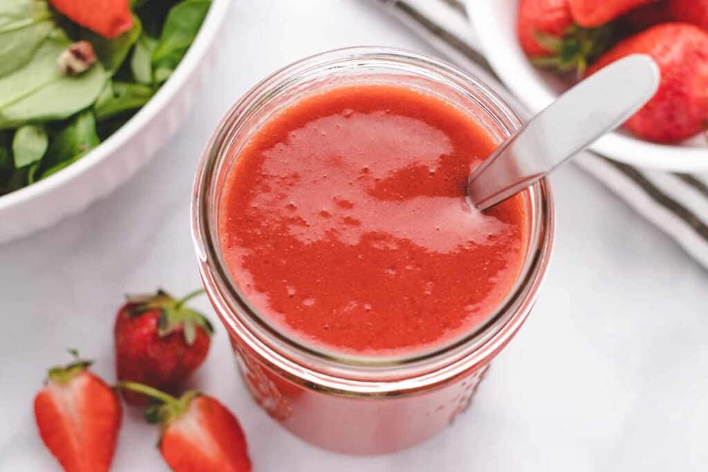 Oil free strawberry vinaigrette in a glass jar.