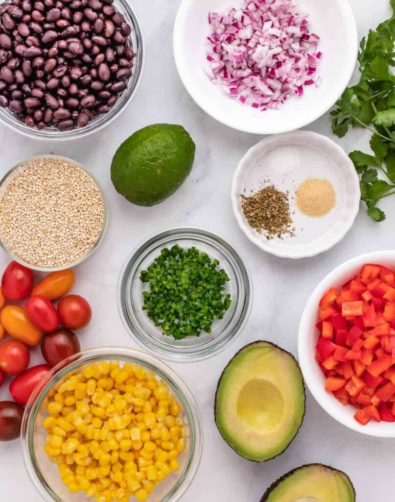 Ingredients for zesty quinoa salad spread out on the counter.