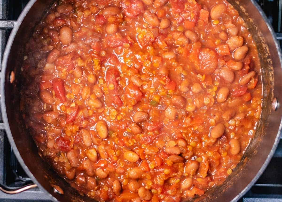 Cooked lentil chili in a large pot.