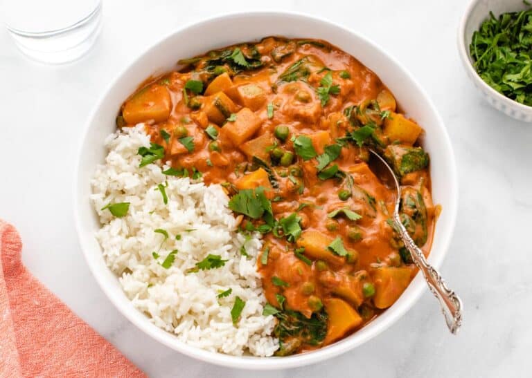 Potato curry with peas and rice in a bowl.