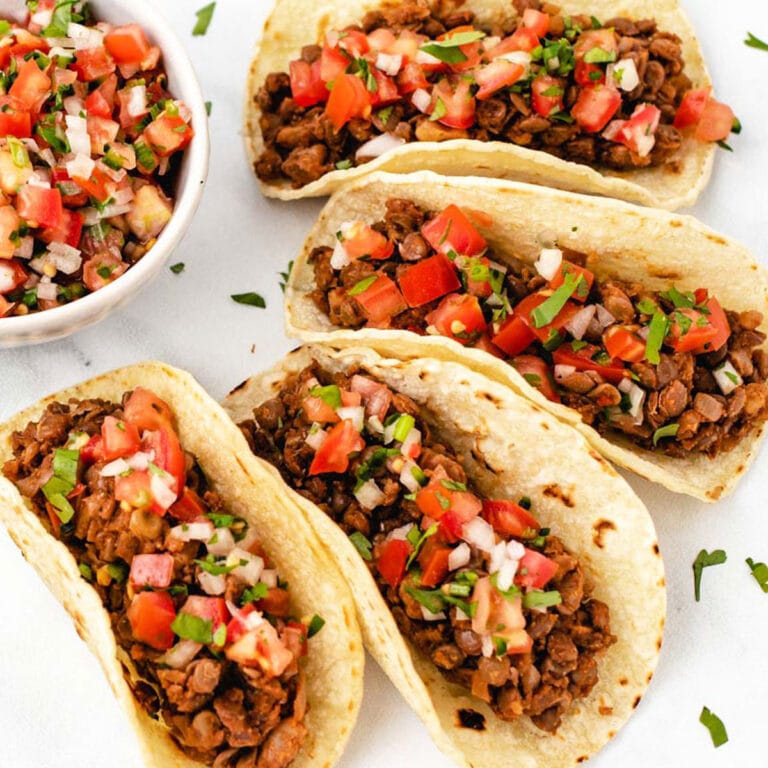 Lentil walnut taco meat in taco shells with pico de Gallo on top.