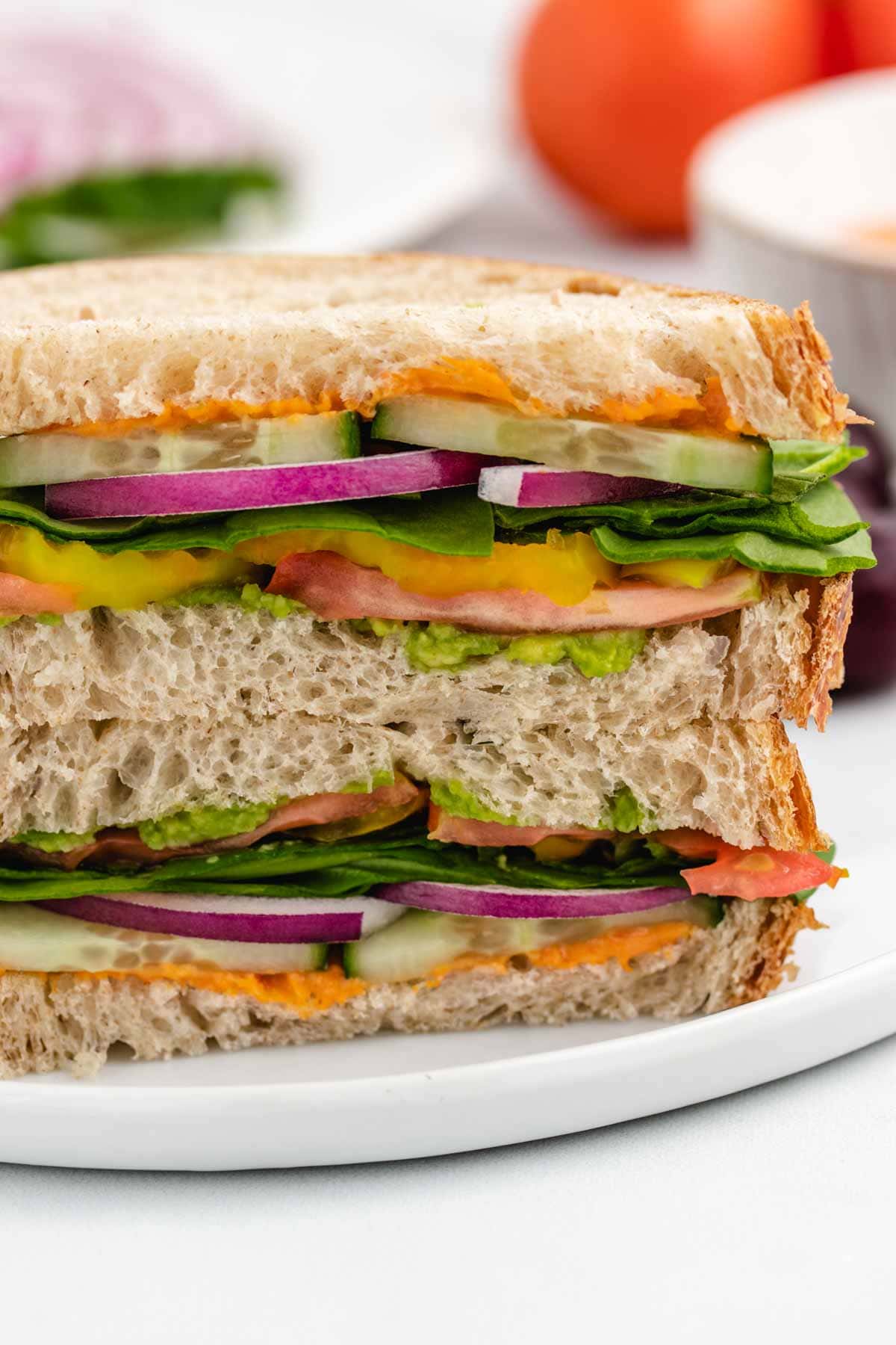 Hummus cucumber sandwich on a plate.