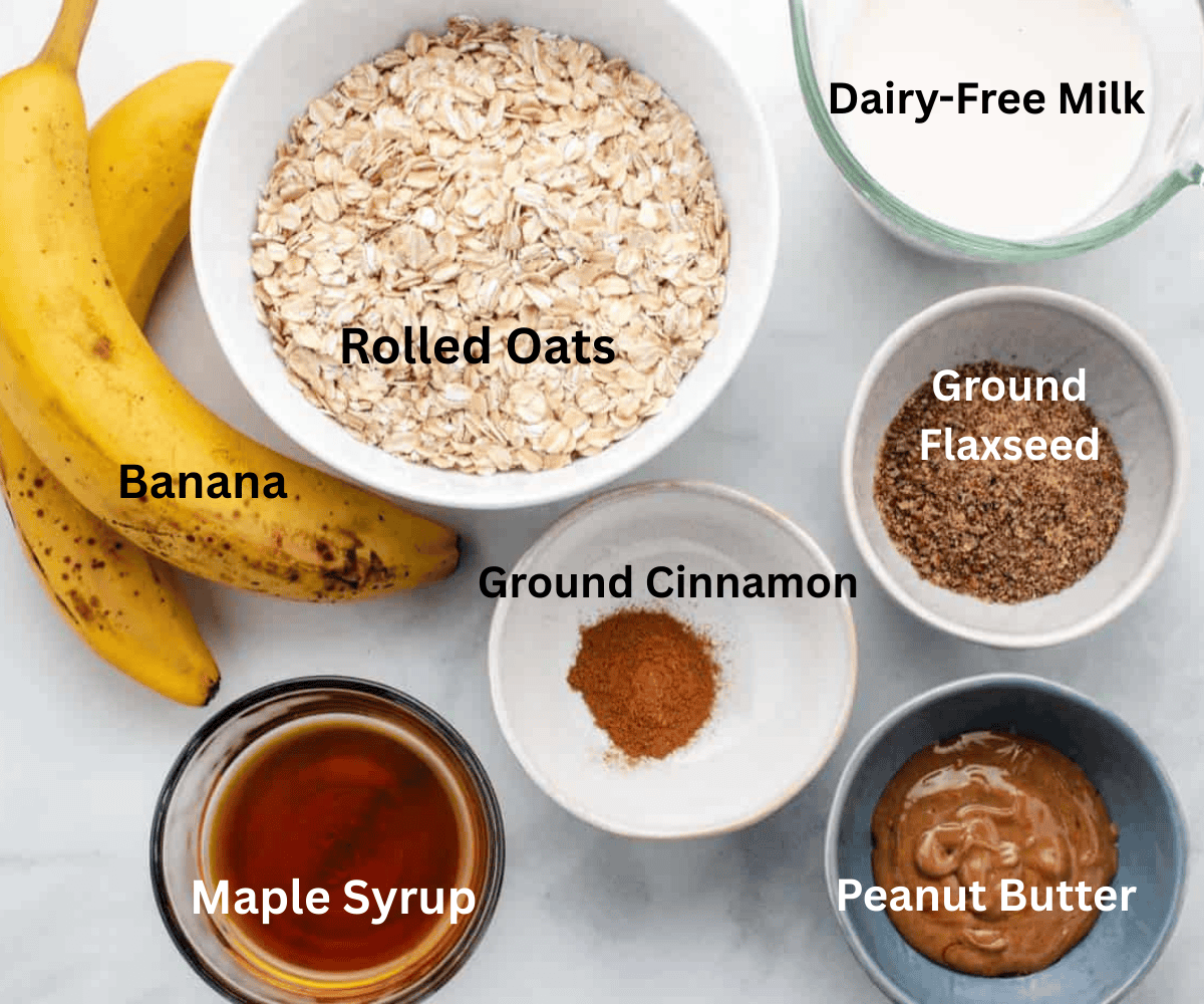 Ripe bananas, a bowl of oats, dairy-free milk, maple syrup, cinnamon, ground flaxseeds, and peanut butter.