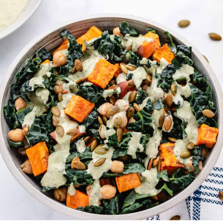 Tahini chickpea bowl with kale and sweet potatoes in a bowl.