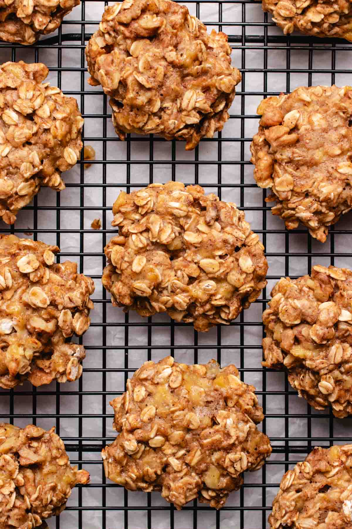 Vegan oatmeal banana cookies on a black cooling rack.