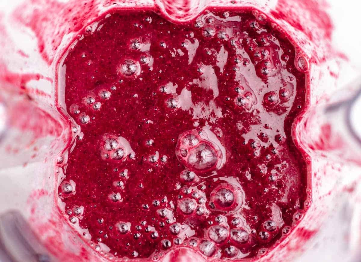 Beets, spinach, an orange, chia seeds, and frozen berries blended smoothie.