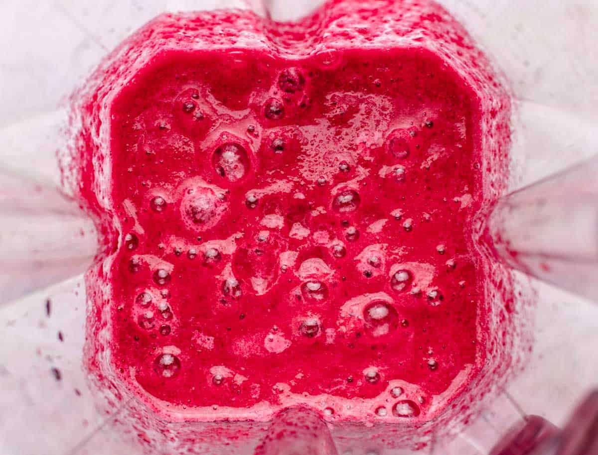 Beet, banana, and pineapple blended in a blender.