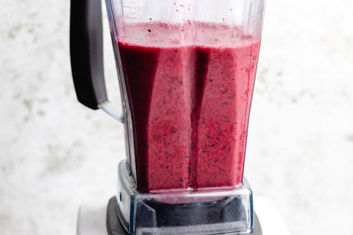 Beets, blueberries, an orange, a banana, and water blended together.