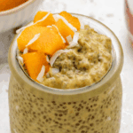 Mango and chia seed pudding in a glass jar with diced mango on top.