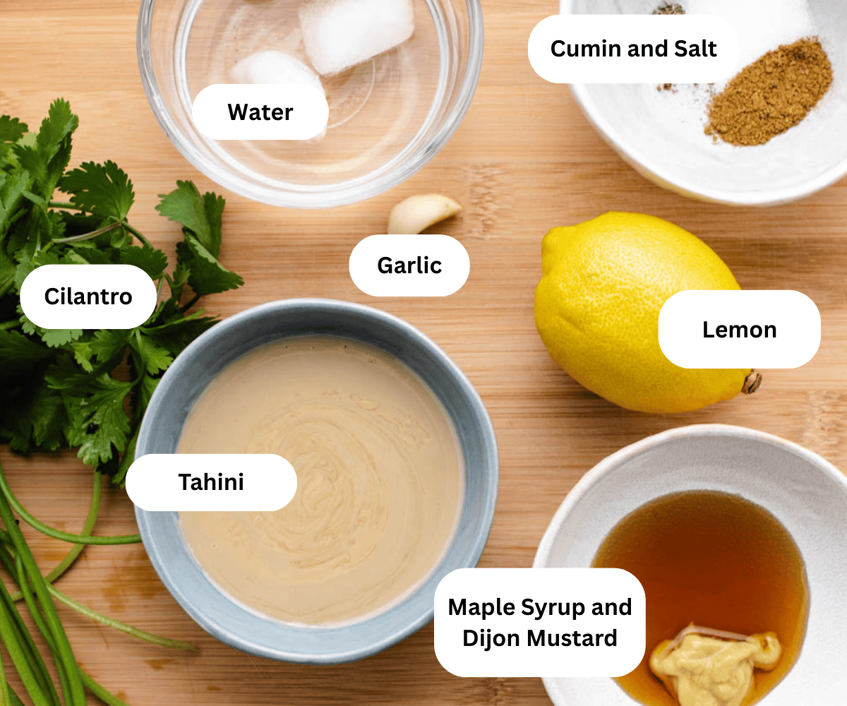 Ice water, cumin, salt, cilantro, tahini, garlic, lemon, maple syrup, and dijon mustard in bowls.