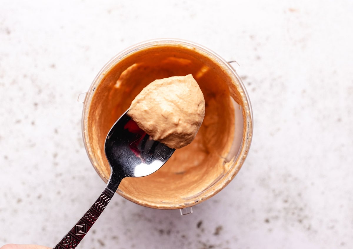 Vegan southwest dressing in a blender and on a spoon.