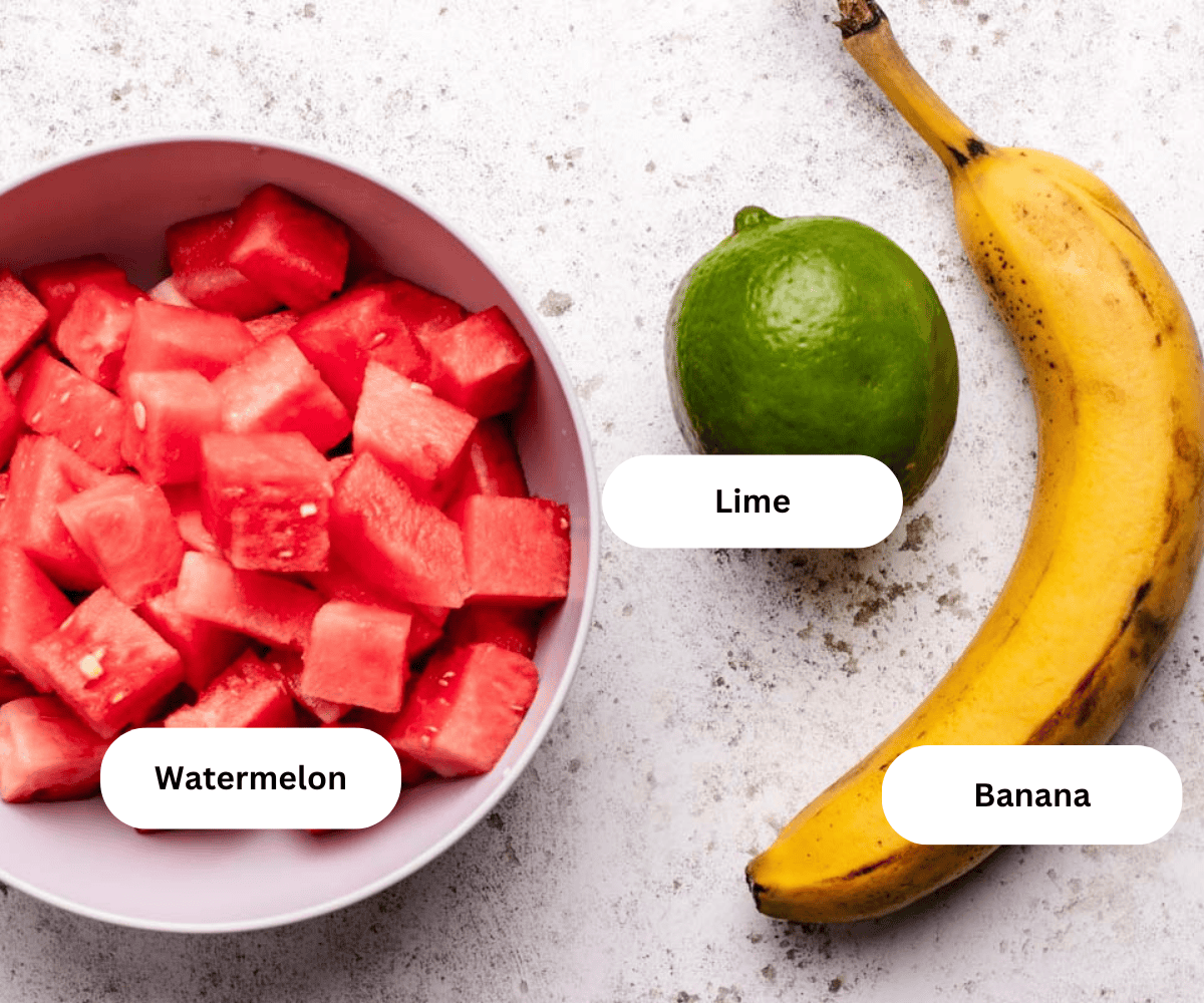 Fresh watermelon diced, a ripe banana, and a lime.
