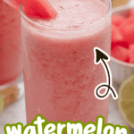 Watermelon banana smoothie in a glass with a watermelon slice and a straw.