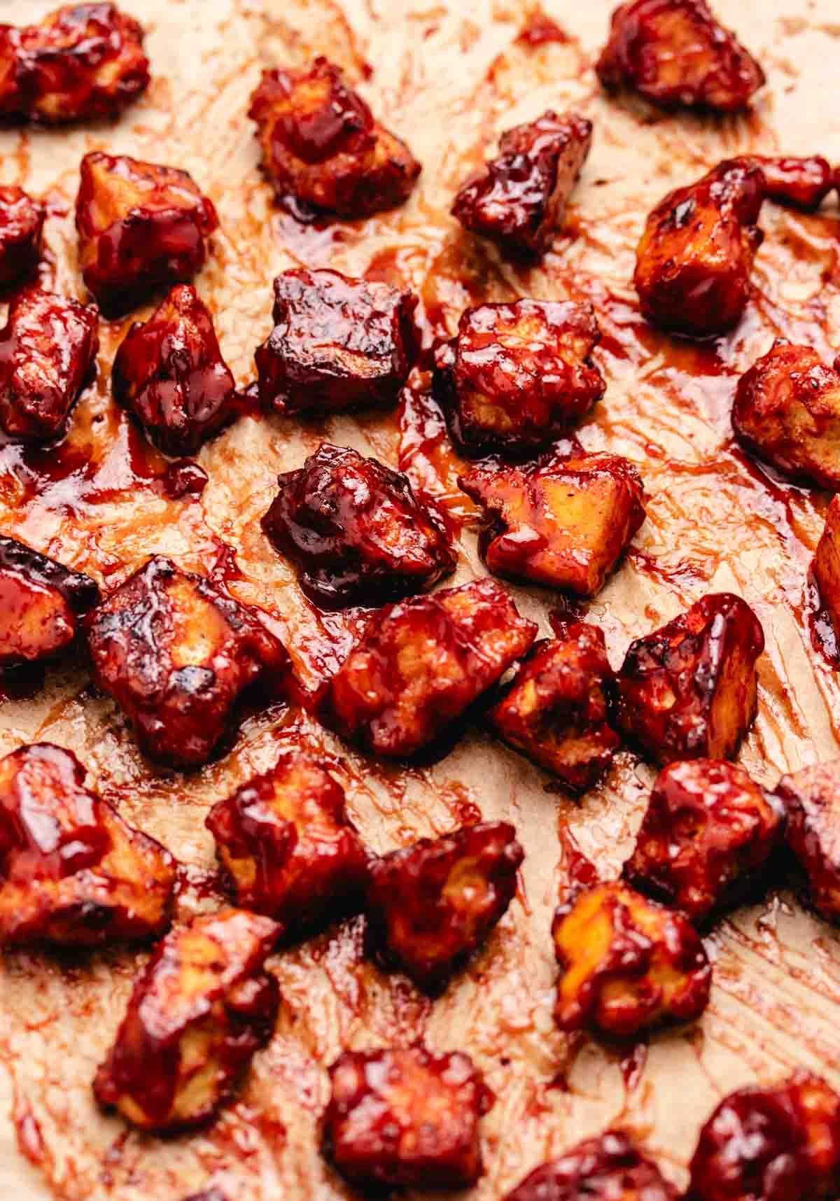 BBQ tofu on a baking tray with parchment paper.