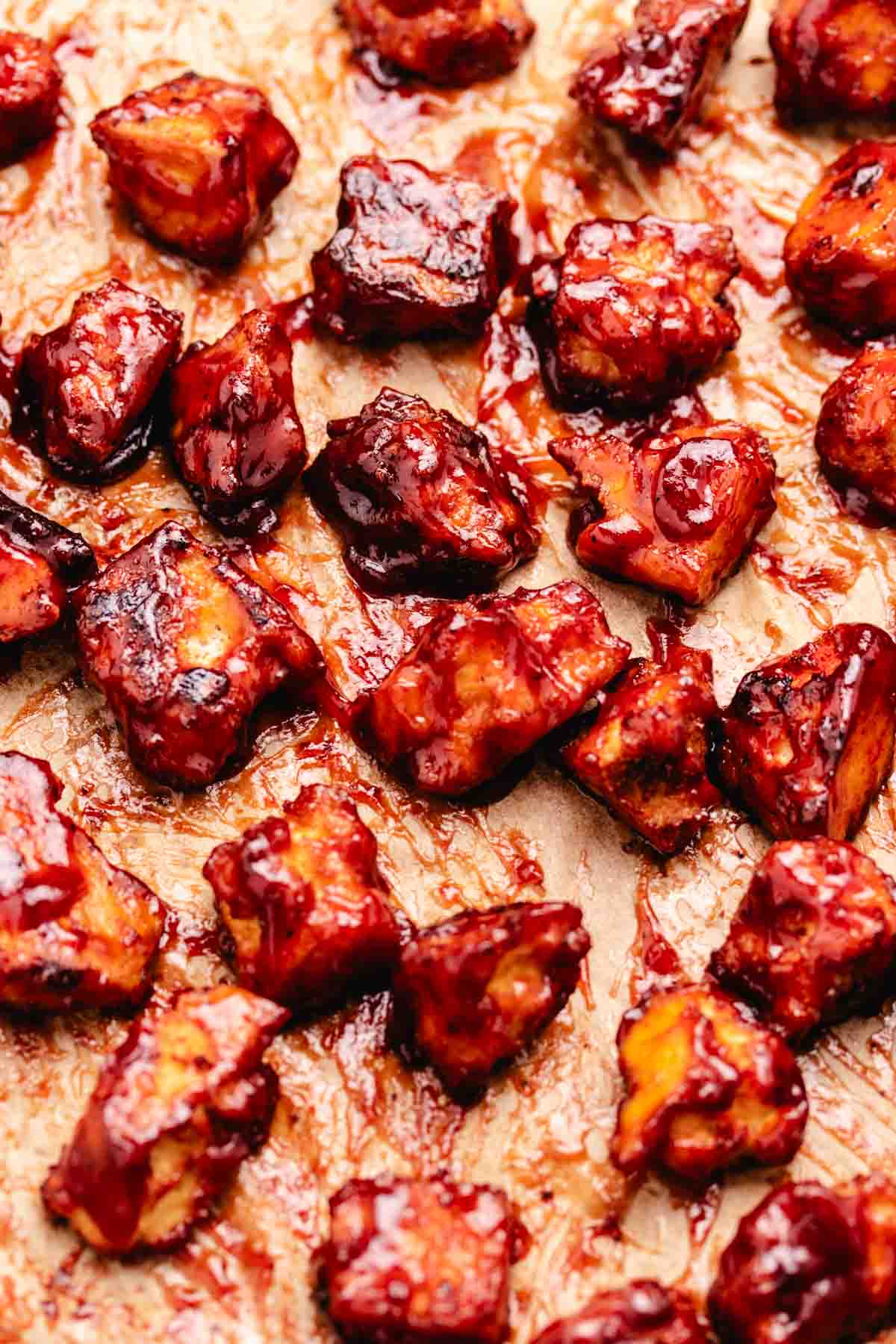 Easy vegan barbecue tofu on a baking tray with parchment paper.