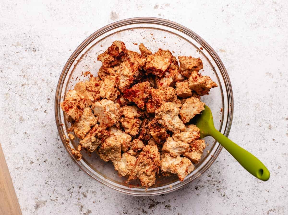 Barbecue tofu pieces in a bowl with spices.
